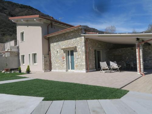 a house with two chairs on a patio at OASI DA VINCI in Tignale