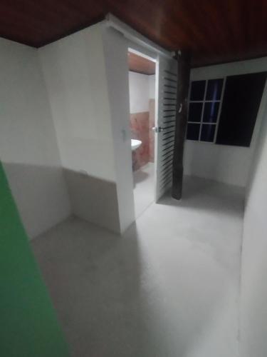 an empty room with a door and a hallway at HOSTAL LAMAR BARU dónde Gertrudis in Playa Blanca