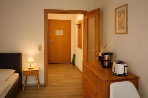 a room with a wooden dresser with a coffee maker on it at Alpenluxe Suite Ferienwohnung in Zwiesel