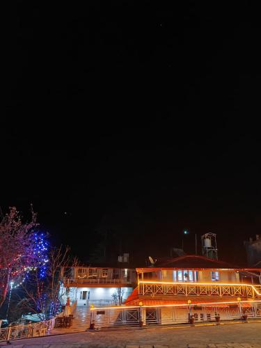 a building with lights on it at night at The Whitegrove Retreat in Mukteswar