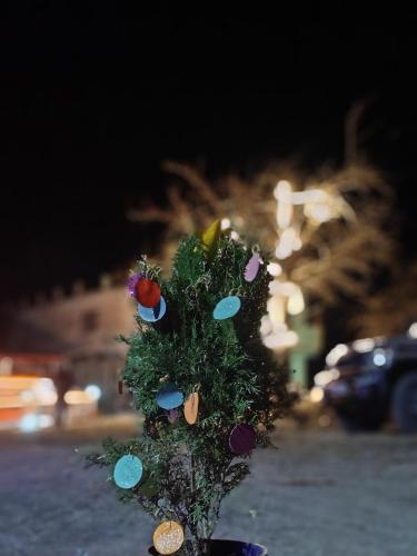 a christmas tree with decorations on top of it at The Whitegrove Retreat in Mukteswar