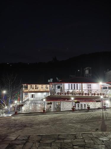 a building at night with lights in front of it at The Whitegrove Retreat in Mukteswar