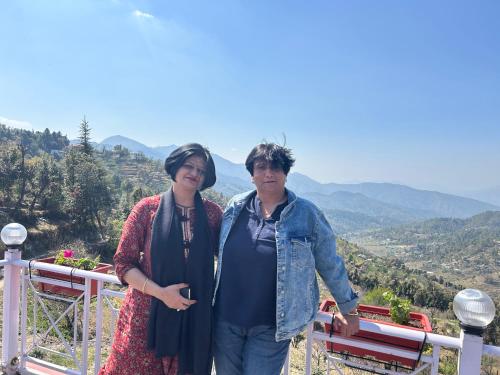 two women standing on top of a mountain at The Whitegrove Retreat in Mukteswar