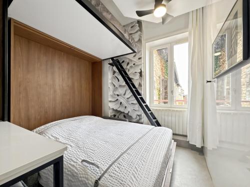 a bedroom with a bed and a window at La White box in Trévoux