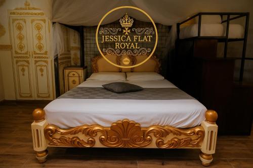 a bed with a sign that reads fiesta hat royal at Jessica Flat Malta Royal Guesthouse in Cospicua