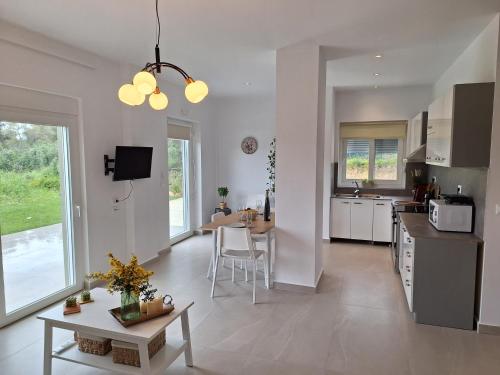 a kitchen and living room with a table and chairs at Iris&Phaedra in Ayiá
