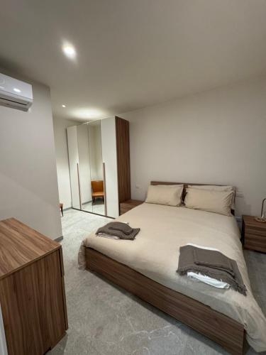 a bedroom with a large bed and a mirror at Casa Lucia in Strada
