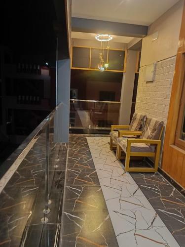 a lobby with a glass counter and a couch at Little Hearts recidency in Āvadi