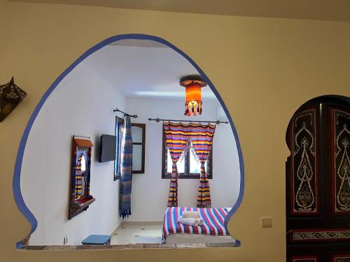 an archway in a room with a chair and a window at Casa Blue Star in Chefchaouene