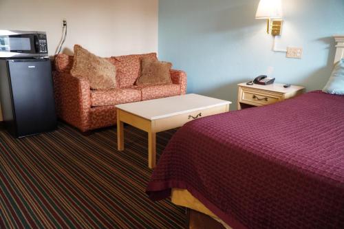 a hotel room with a bed and a couch at Richmond - Quality Quarters Inn in Richmond