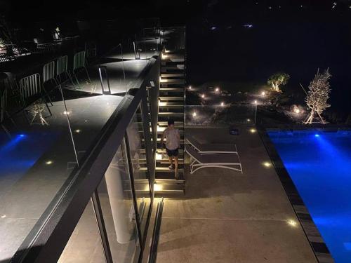 a person walking down the stairs of a house at night at Chuỗi Villa 6 ngủ Siêu VIP Tuần Châu S-H - Mặt Biển - View vịnh in Ha Long