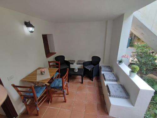 a small living room with a table and chairs at Emadi House Porto Rotondo in Porto Rotondo