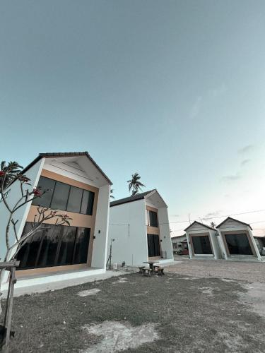 a row of houses in a parking lot at Eastcape Studio by The White Sands Homestay in Pekan