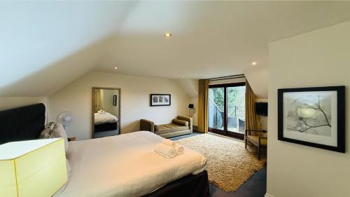 a bedroom with a bed and a living room at Hustyns Hotel in Wadebridge