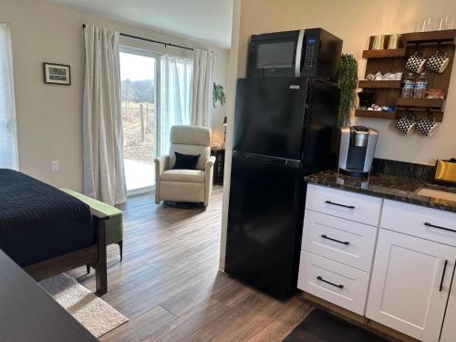 a kitchen with a black refrigerator in a room at Riesling Retreat in Cottonwood