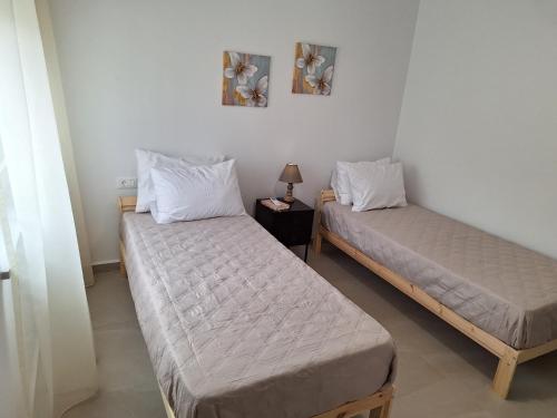 two twin beds in a room with at Iris&Phaedra in Ayiá