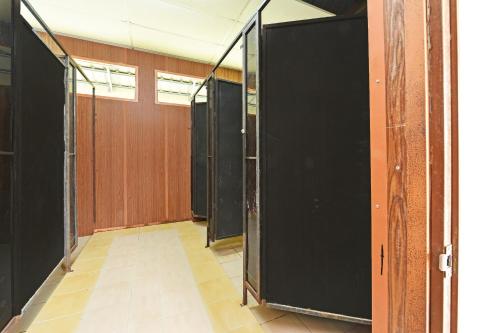 a hallway with a row of stalls in a building at Hotel O Otternest @ Gunung Pulai 2 in Pontian Besar