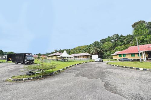a road with a car parked on the side at Hotel O Otternest @ Gunung Pulai 2 in Pontian Besar