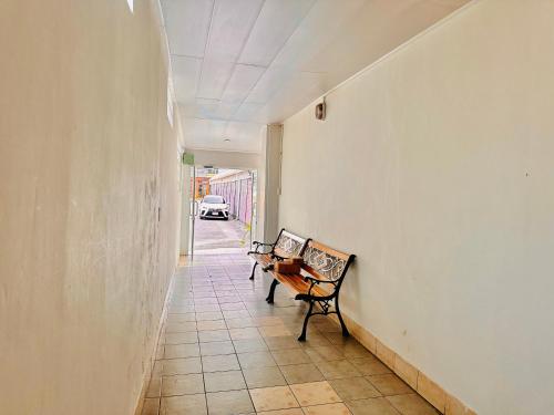 a hallway with a table and a bench in a room at Patong best location Apartments, 2 bedrooms in Patong Beach