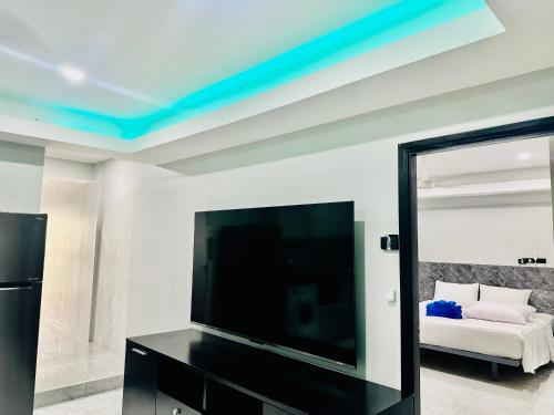 a living room with a flat screen tv and a couch at Patong best location Apartments, 2 bedrooms in Patong Beach