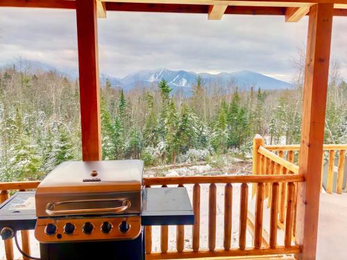 a grill on a porch with a view of the mountains at 84UVR in Bethlehem