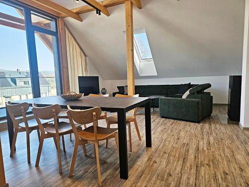 a dining room with a table and chairs at Apartmán Nad Údolím Šumava in Prachatice