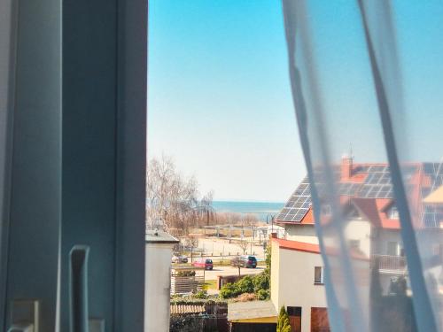a view of the ocean from a window of a building at Konik Morski in Jastarnia