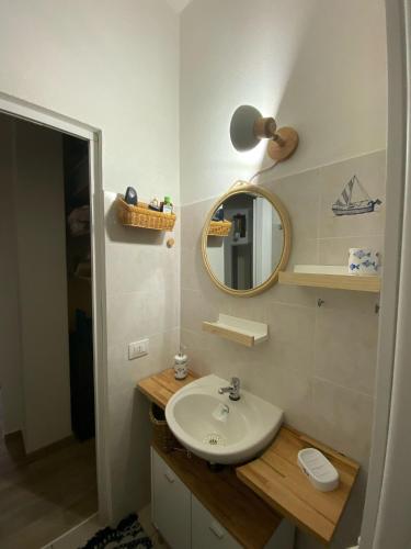 a bathroom with a sink and a mirror at Costa relax in Costa Rei
