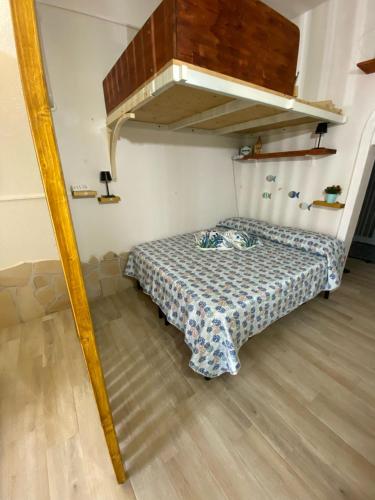 a bedroom with a bed in a room with a loft at Costa relax in Costa Rei