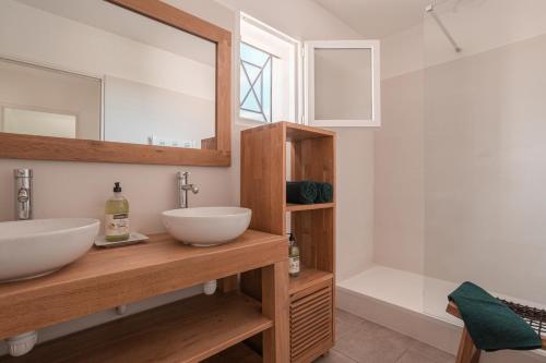 une salle de bain avec deux lavabos et un miroir dans l'établissement Petit Paradis Garrigue, à Moulézan