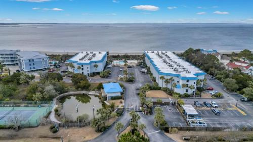 an aerial view of a parking lot next to the ocean at Private Balcony - Beach - Pool and Pickleball in Tybee Island