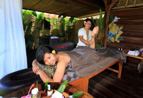 a woman laying in a bed in a room at Sawah Indah Villa in Sidemen
