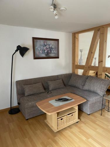 a living room with a couch and a table at Ferienwohnung Carmen in Krakow am See