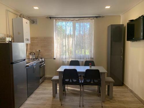 a kitchen with a table and chairs and a refrigerator at Tumanyan Guesthouse in Dsegh