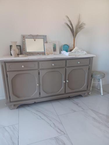 a gray cabinet with a mirror on top of it at Apartment Dry dock in Postira