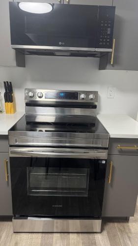 a black oven in a kitchen with a microwave at 1 bedroom- 1 bath private suit in Regina