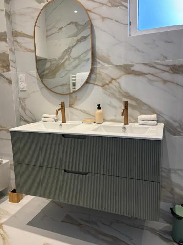 a bathroom with a sink and a mirror at CANNES Maison Design "DOLCE VITA" in Cannes