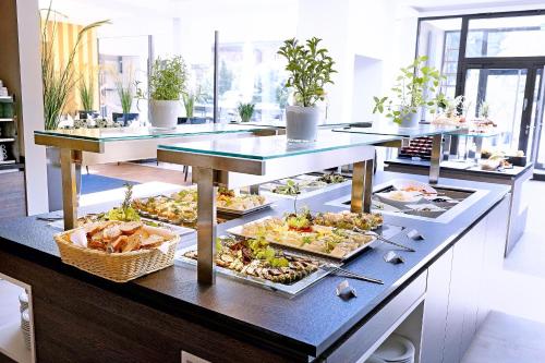 a buffet line with many different plates of food at Schlosshotel Kassel in Kassel