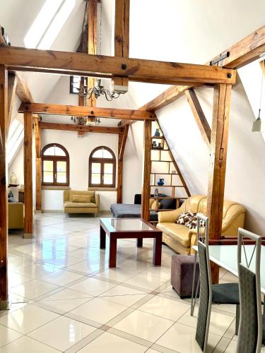 a living room with wooden beams and a table at Wroclaw Inn Apartments in Wrocław