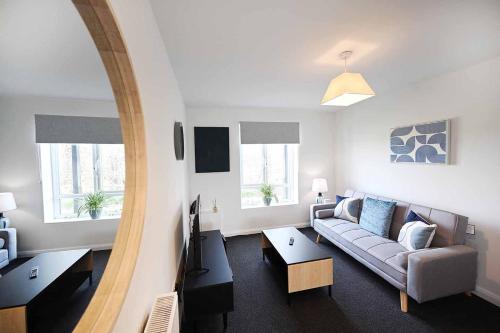 a living room with a couch and a mirror at 2bed Cowgate next Newcastle Golf Club Free Parking in Kenton