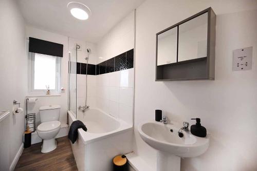 a white bathroom with a sink and a toilet at 2bed Cowgate next Newcastle Golf Club Free Parking in Kenton