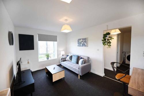 a living room with a couch and a tv at 2bed Cowgate next Newcastle Golf Club Free Parking in Kenton