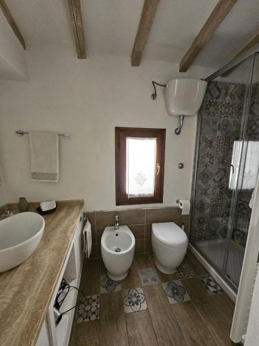 a bathroom with a sink and a toilet and a shower at Il nido dei Priori in Volterra