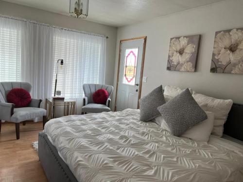 a bedroom with a large bed and two chairs at Mixon villas in Waterbury