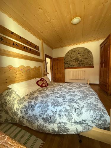a bedroom with a large bed in a room at La Ciasa Dell'Emigrante in Cibiana