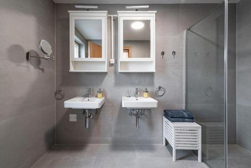 a bathroom with two sinks and a shower at Novi Sad's Quiet Quarters in Novi Sad