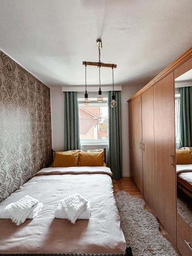 a bedroom with a large bed and a window at PARK Apartment in Bijeljina
