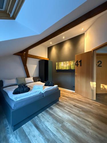 a bedroom with a large bed in a room at Ho(s)tel Ahrbergen in Giesen