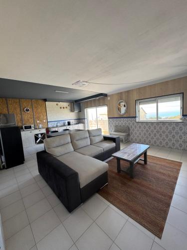 a living room with a couch and a table at vue mer in Pataias
