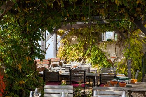 an outdoor dining area with tables and chairs and trees at Schloss Kapfenstein in Kapfenstein